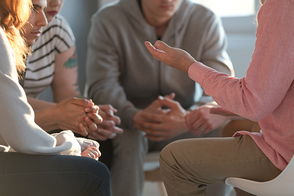 Group sits in circle talking